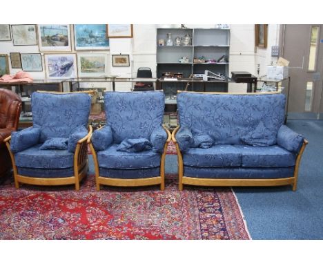 AN 'ERCOL' THREE PIECE SUITE, with blonde frame and blue upholstered loose cushions