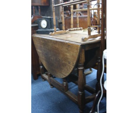 AN OAK GATE-LEG TABLE