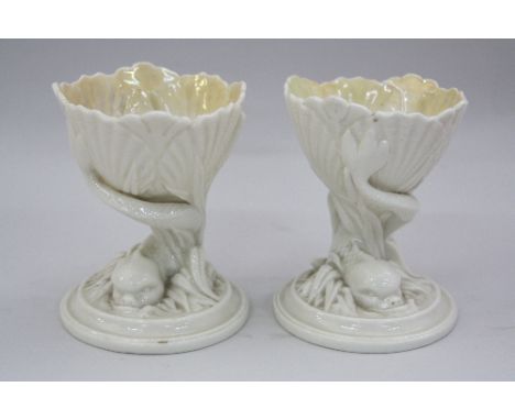 A PAIR OF ROYAL WORCESTER TABLE SALTS, in the form of shell being supported by fish on circular base, impressed mark to base 