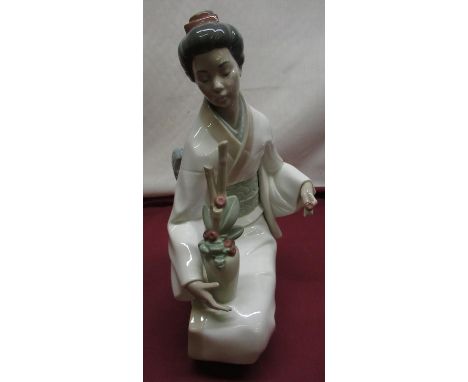 Nao model of seated Geisha arranging flowers, H36cm 