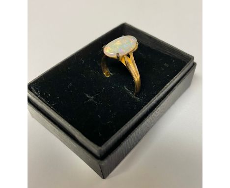 9ct yellow gold ring with oval claw set opal, stamped 375, size N with resizer, gross 2.5g 