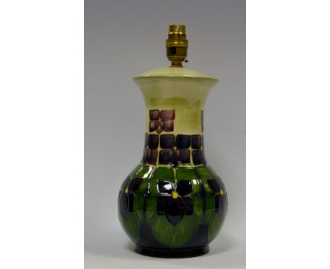 A contemporary Moorcroft lamp base, tube lined with stylised flowers and foliage, in tones of purple, blue and green, 26cm hi