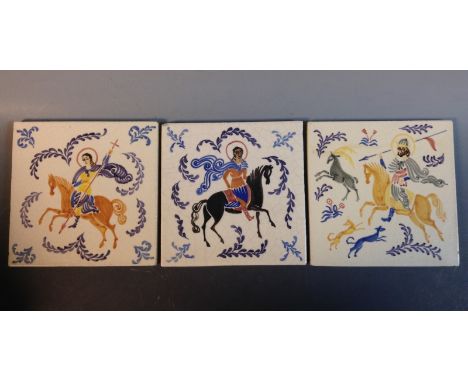 A set of three Poole square tiles, each painted with stylised saints on horseback, 15cm square