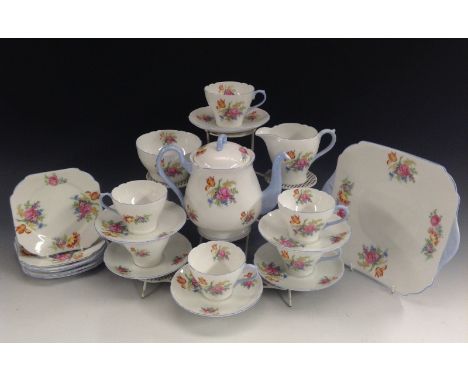 A Shelley New Cambridge shape tea set for six, printed with summer flowers, picked out in sky blue, comprising teapot, milk a