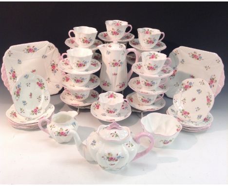 A Shelley Dainty shape tea set, printed with colourful sprays of summer flowers, comprising teapot, milk jug and sugar bowl, 