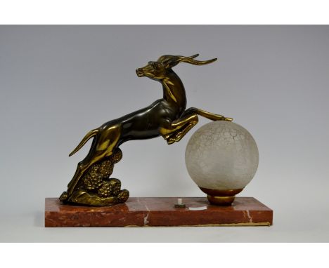 An Art Deco spelter and marble side light, frosted globular shade, the rouge marble rectangular base with gilt rearing deer, 