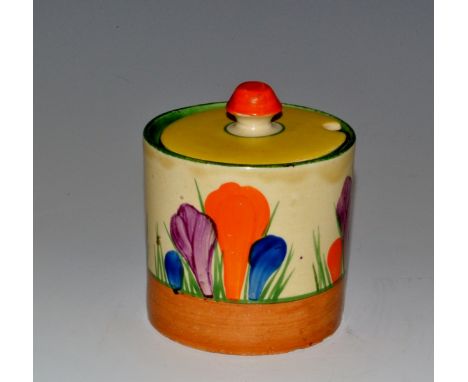 A Clarice Cliff Crocus pattern cylindrical preserve pot and cover, brightly decorated with purple, blue and orange flowers, b
