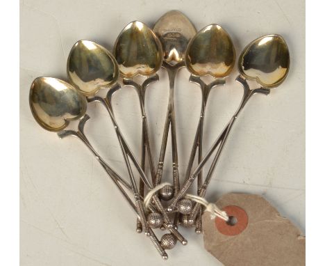 A set of six late Victorian silver golfing teaspoons each with a harp shaped bowl and a stem of two crossed golf clubs and a 