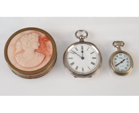 A silver cased key wind fob watch, one other fob watch and a compact with a cameo lid.   Condition Report: Compact closes pro