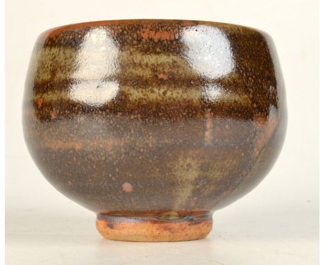 A Leach Pottery stoneware tea bowl with an olive and tenmoku glaze, impressed seal mark to side, height 9cm. 