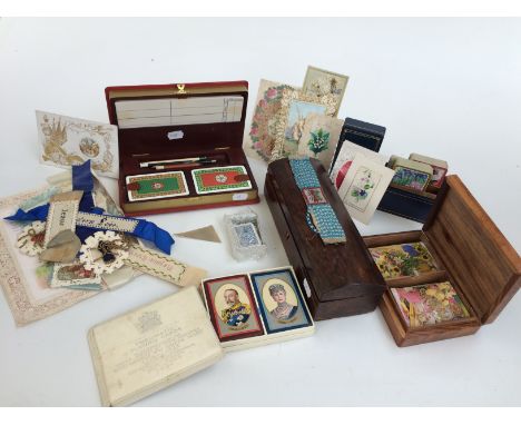 A collection of early greetings cards, cross stitch motto bands, a beaded bracelet and a rosewood glove box together with a c