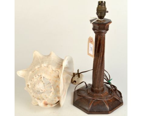 An oak Arts and Crafts table lamp with A&C label together with a conch shell.