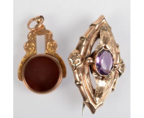 A gold and amethyst Victorian brooch and a gold swivel fob.