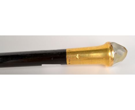 An ebony walking stick, the 18ct gold plated mount with a faceted crystal finial, ivory ferrule, length 91.5cm.