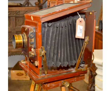 A Thornton-Pickard Ruby plate camera with single book plate carrier and folding wooden tripod.