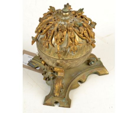 An ornate spherical mixed metal gilt and silvered inkwell with a gilt floral cast mount on a concave trefoil base, height inc