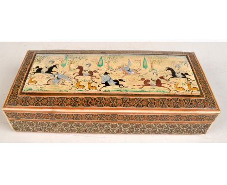 A Persian cigarette box painted with a hunting scene and star inlay, width 21.8cm. 