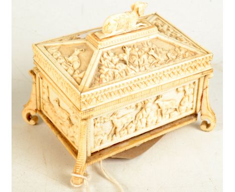 A good Black Forest bone jewel casket carved with a dog finial, the panels showing mountain goats, on scrolling feet, width 1