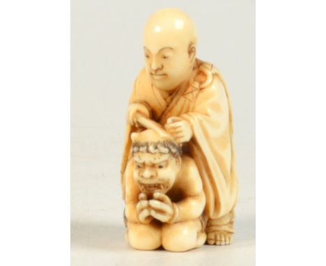 A late 19th century ivory netsuke showing a Shinto priest cutting off the horns from an Oni, who has declared himself to beco