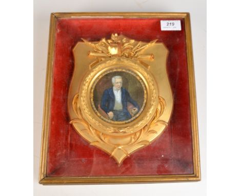A Staffordshire pot lid with a portrait of "The Late Duke of Wellington" ornate border and mounted in a glazed cabinet with a