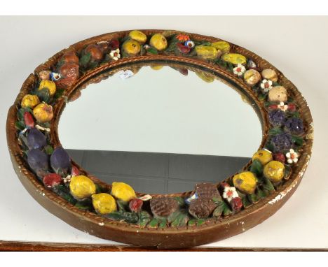 A Della Robbia style circular mirror in a plaster, fruit and pine cone moulded frame, diameter 72cm. 