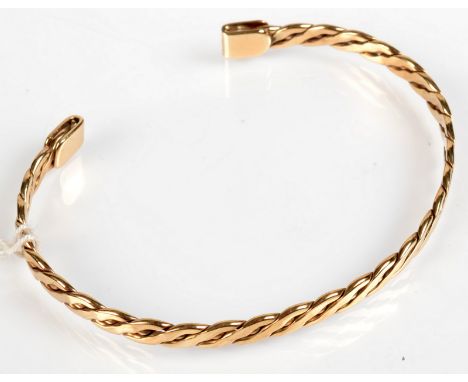 An entwined 9ct. gold bangle, 9.8g.