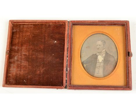 A daguerreotype portrait of a gentleman.  Condition Report: The plate has some dark marks and surface scratches.
