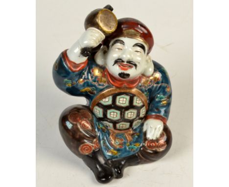 A Japanese Kutani seated, coloured enamelled figure of Daikoku holding his magic mallet, height 16cm and another Daikoku hold