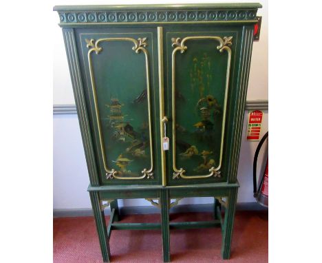 A chinoiserie green ground lacquered secretaire with a pair of doors opening onto drawers, niches and a falling writing slope