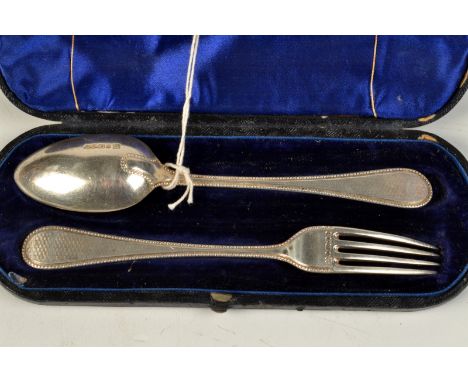 A child's Victorian engine turned and beaded spoon and fork, cased.
