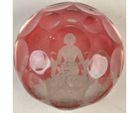 A Bohemian faceted paperweight the red flash ground cut to show the portrait of a seated lady holding a plant, diameter 7.6cm