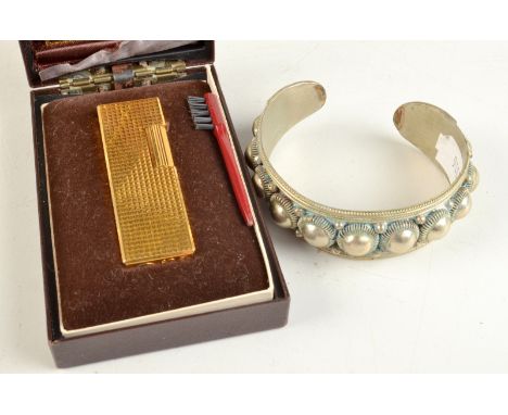 A gold plated lighter by Colibri, original box, together with an African bangle.