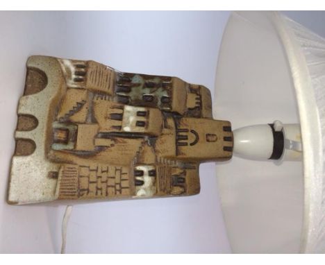 A Tremaen Pottery lamp moulded on each side a coastal village, height 17.5cm. 
