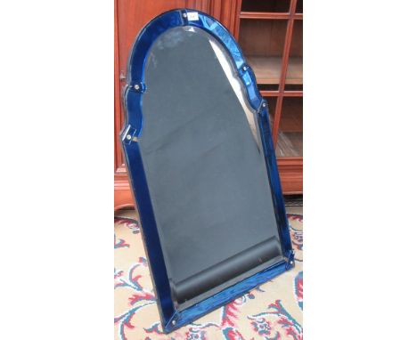 An arched mirror with mirrored blue glass frame, height 89cm, width 53cm.