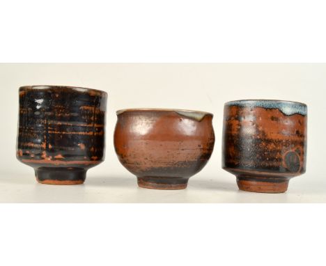 A Trevor Corser Leach Pottery yunomi and two other tenmoku glazed yunomi. 