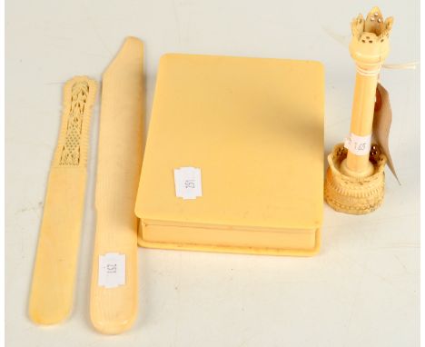 An ivory ornamental turned thermometer, two ivory paper knives and a celluloid box.