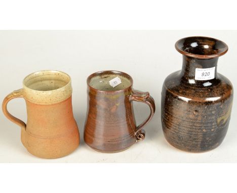 A Leach Pottery tenmoku glazed bottle vase, height 19cm, together with a Leach Pottery standard ware one pint mug and a Winch
