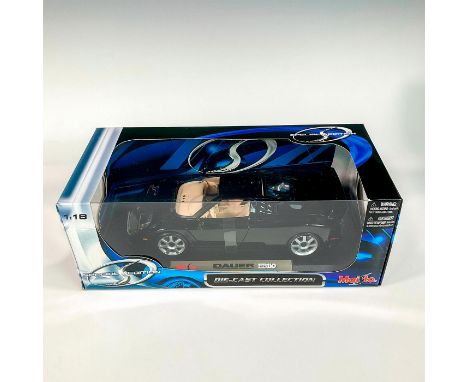 A factory sealed, replica die cast model Dauer EB 110 in a black exterior and tan interior. With moveable parts. This item ha