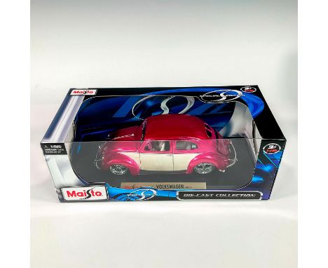 A factory sealed, replica die cast model Volkswagen in a pink and white exterior. With moveable parts. This item has its orig