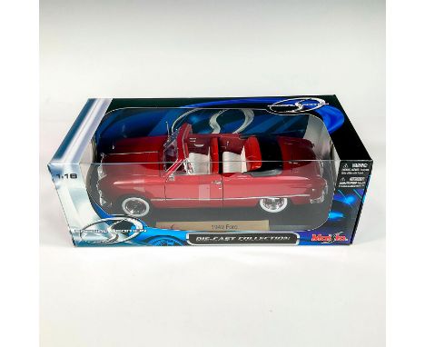 A factory sealed, replica die cast model Ford in a red exterior, and white and red interior. With moveable parts. This item h