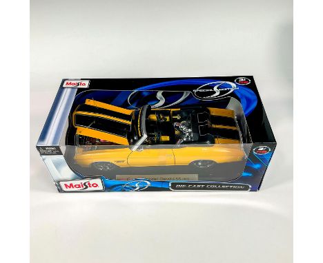 A factory sealed, replica die cast model Chevrolet in a yellow exterior. With moveable parts. This item has its original box: