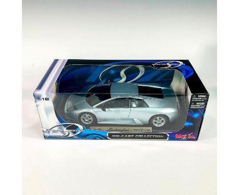 A factory sealed, replica die cast model Lamborghini in a silver exterior. With moveable parts. This item has its original bo