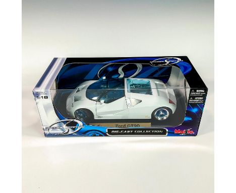 A factory sealed, replica die cast model Ford in a white exterior. With moveable parts. This item has its original box: 12.5â