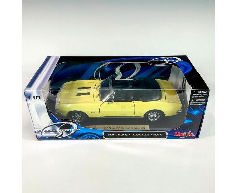 A factory sealed, replica die cast metal Chevrolet Camaro RS/SS 396 designed in a soft yellow exterior and black interior wit