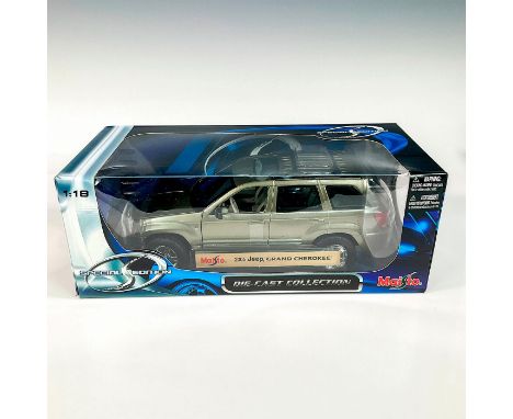 A factory sealed, replica die cast metal model car designed in a metallic green and black exterior, made with detachable part