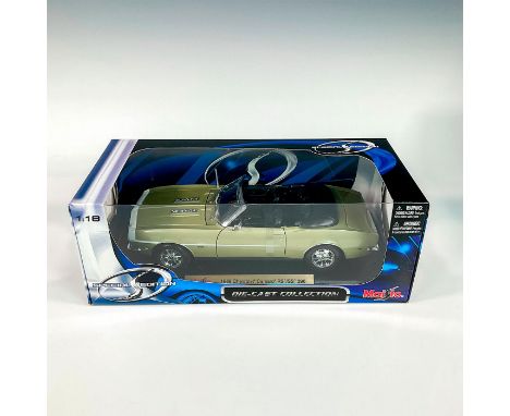 A factory sealed, replica die cast metal model car Chevrolet Camaro RS/ SS 396 designed in a green exterior with a black inte