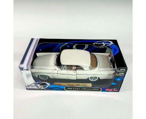 A factory sealed, replica model car designed in a white exterior with cream colored interior, made with detachable parts. Inc