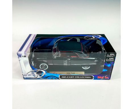 A factory sealed, replica die cast metal car designed in a black exterior with a red and black interior. Includes a black dis