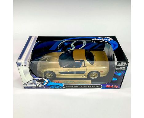 A factory sealed, replica die cast model Corvette in a gold exterior. With moveable parts. This item has its original box: 12