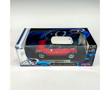 A factory sealed, replica die cast model Mini Cooper in red and white exterior. With moveable parts. This item has its origin
